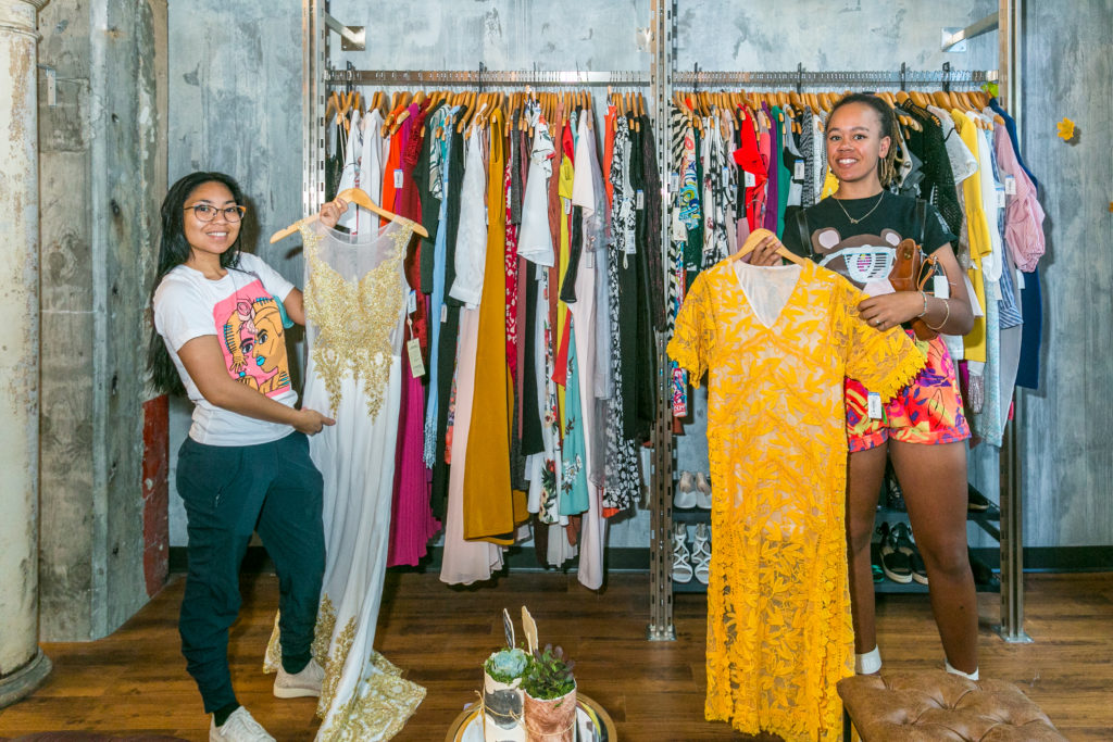 SF Goodwill shoppers holding up their thrifted dresses at 750 Post Store.