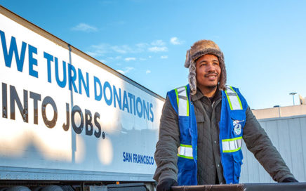 Donation attendant in front of Goodwill donation truck