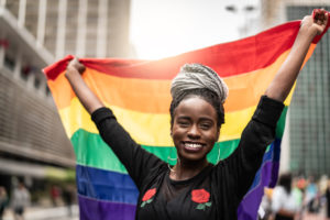 woman waving rainbow flag
